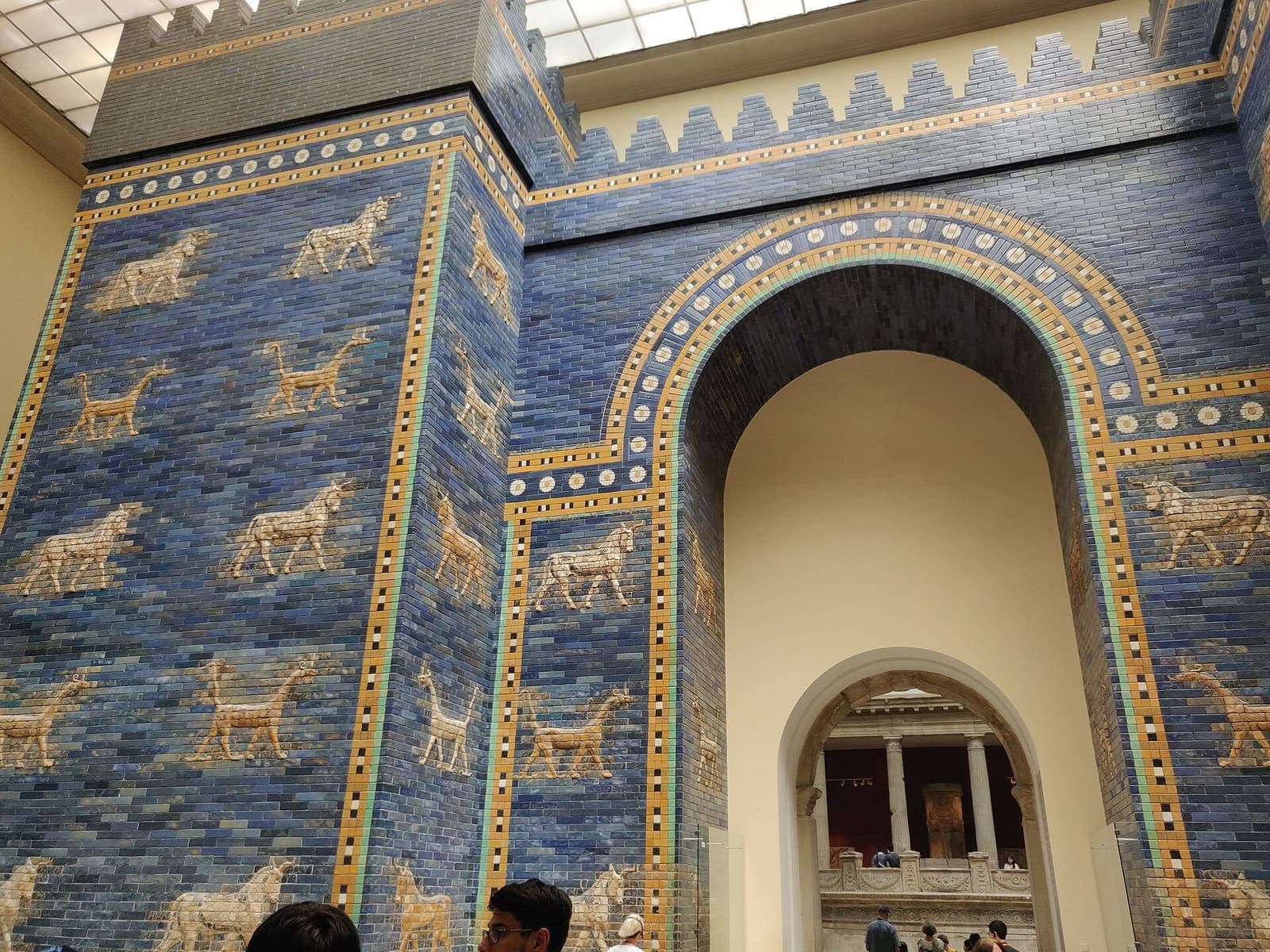 A tall arched gateway faced in glazed blue brick decorated with animals.