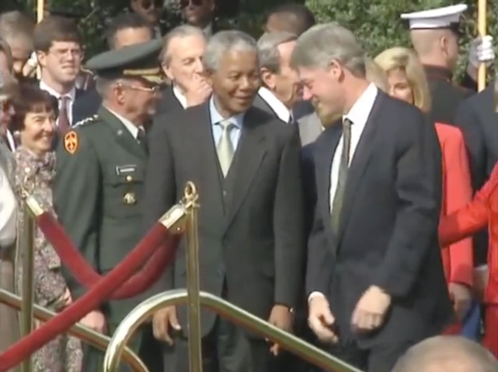 Nelson Mandela being received at a formal occasion.