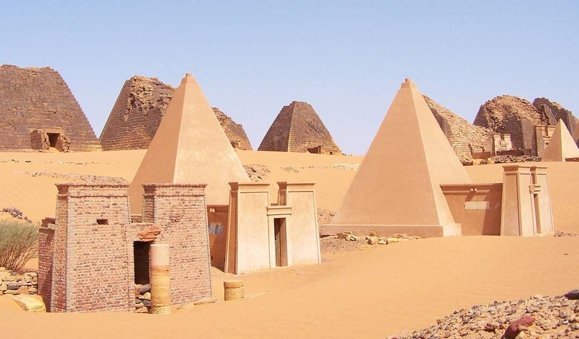 Steep-sided sandstone pyramids rising from desert at Meroë.