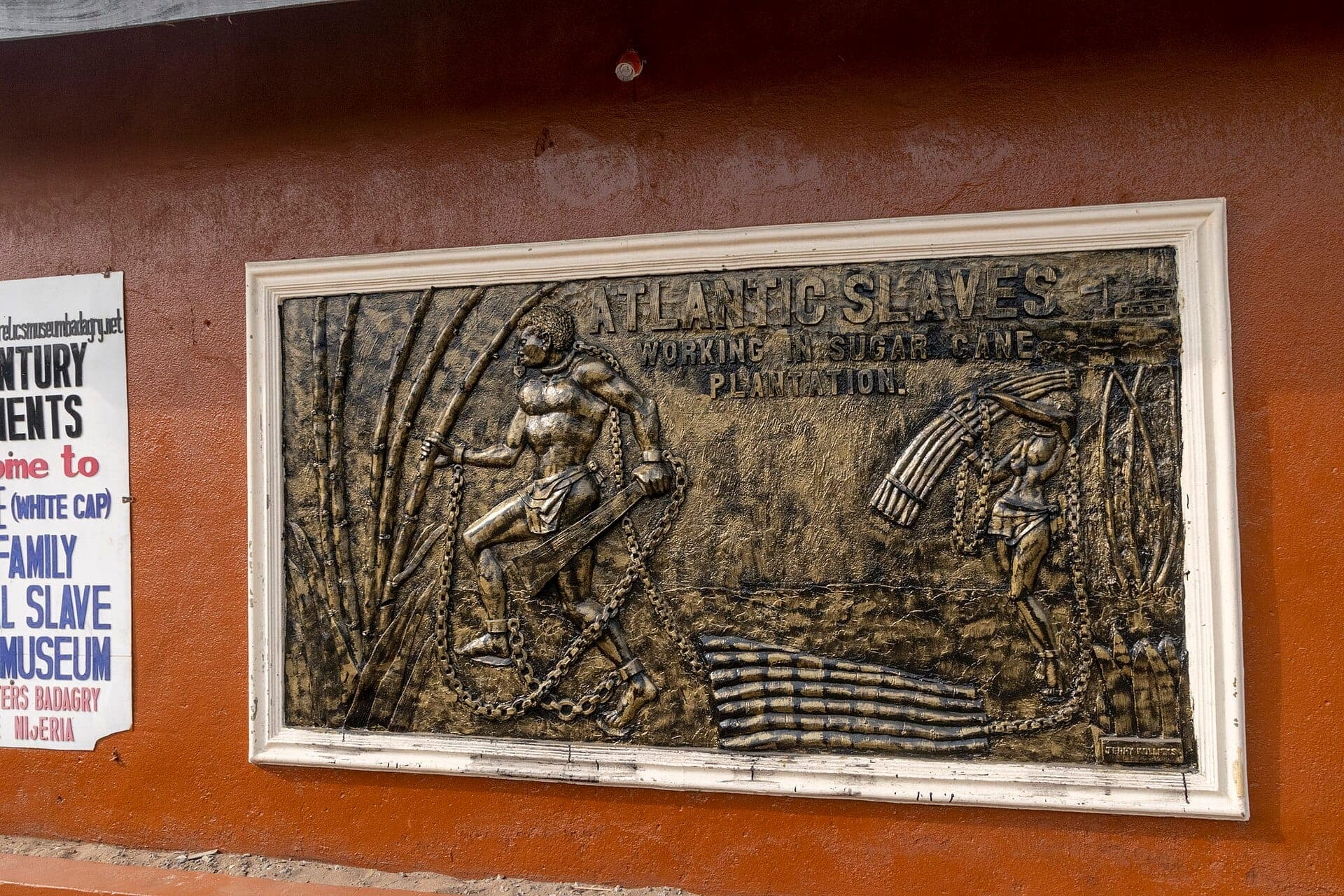 Artwork depicting slavery on the side of the Mobee Royal Family Slave Relics Museum.